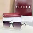 Gucci sunglasses with dark frame, deep purple gradient lenses, gold accents