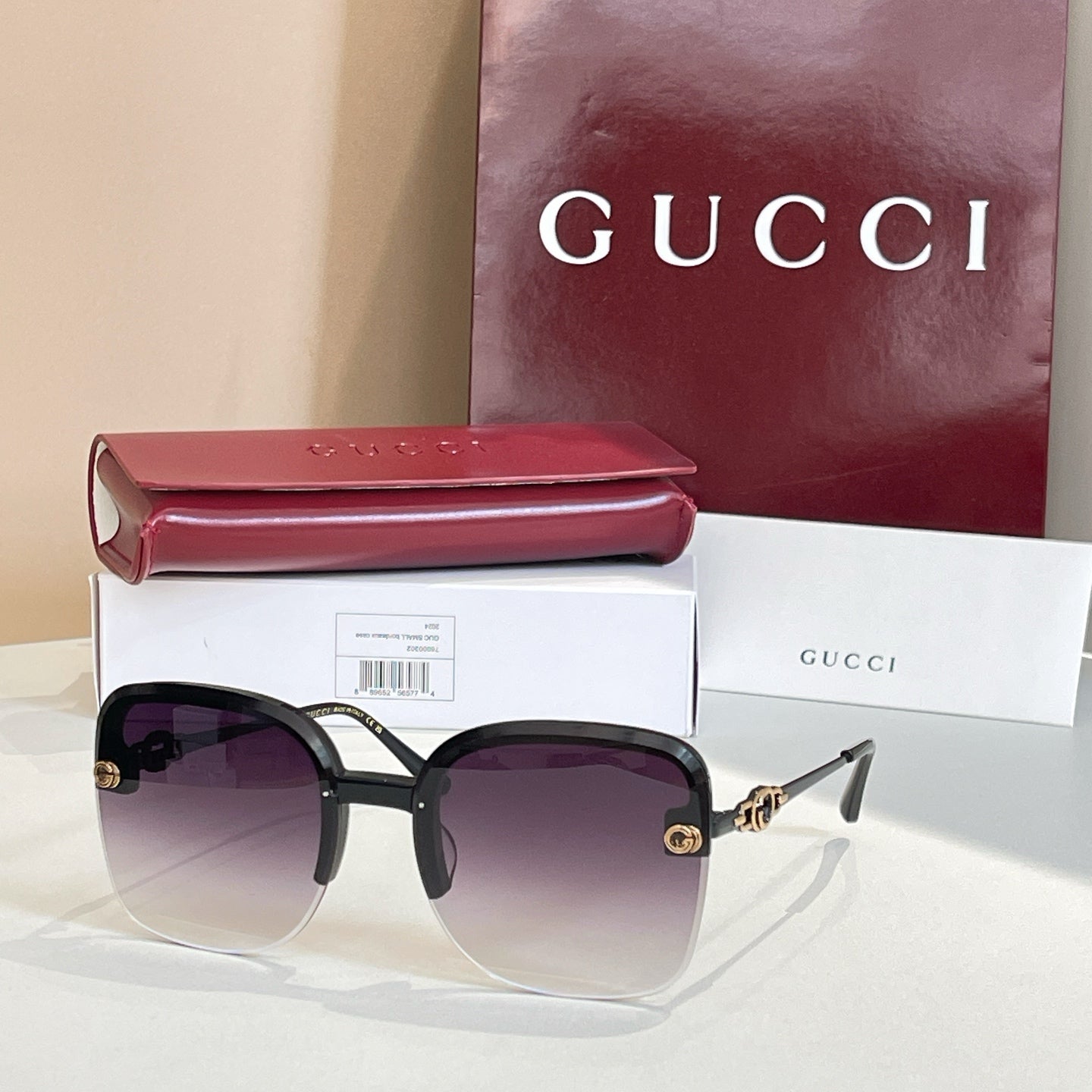 Gucci sunglasses with dark frame, deep purple gradient lenses, gold accents