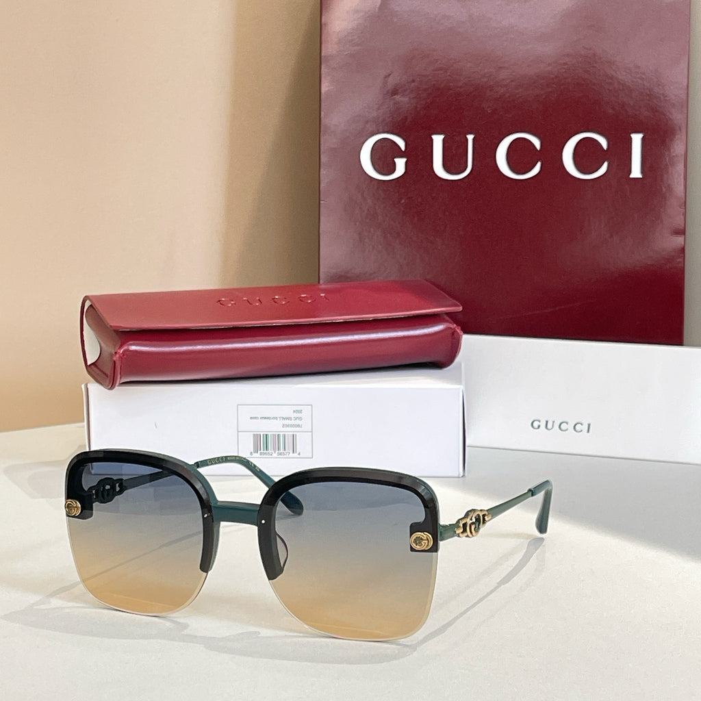 Gucci sunglasses with dark frame, gradient amber lenses, gold logo accents