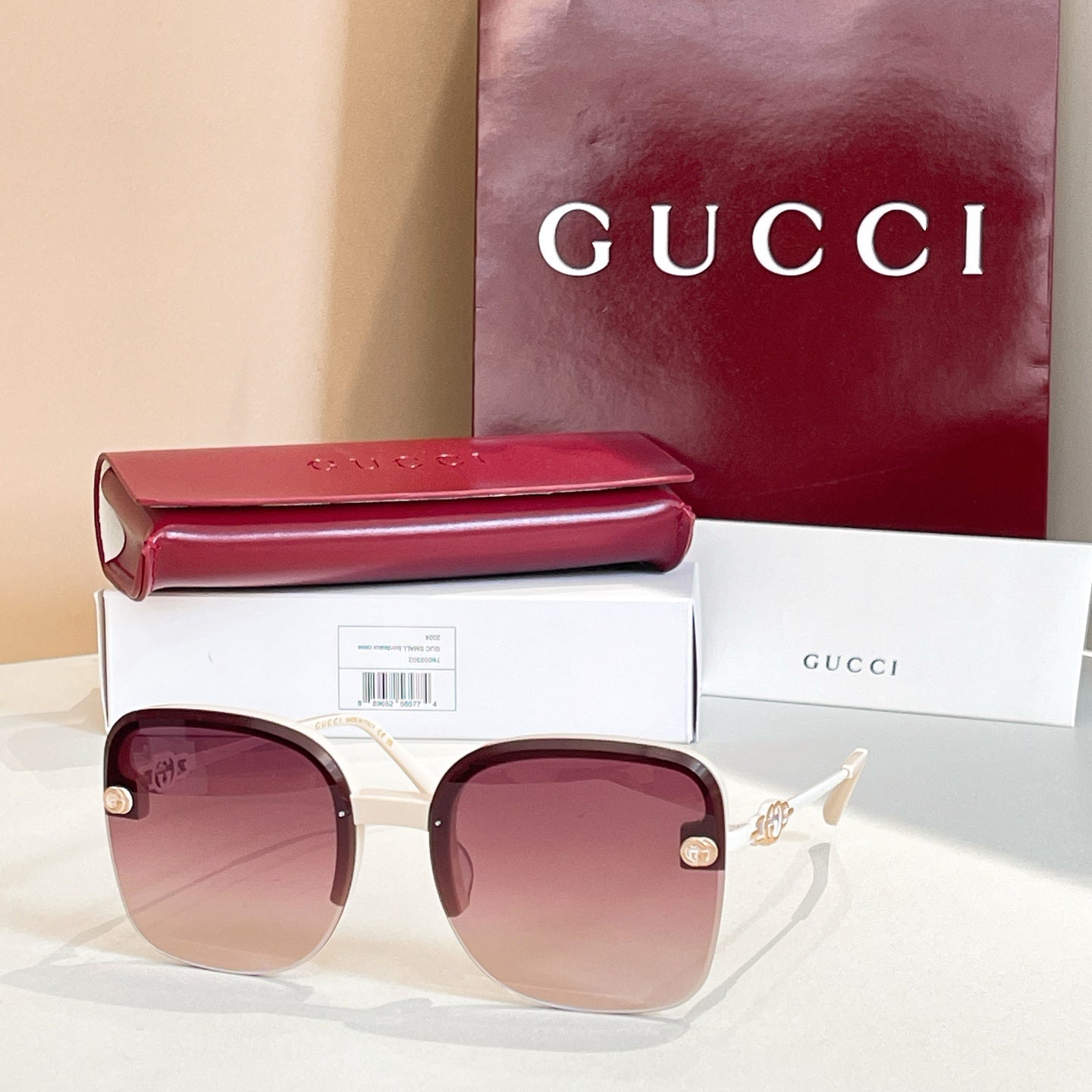 Gucci sunglasses with brown frame, rose-tinted gradient lenses, gold accents
