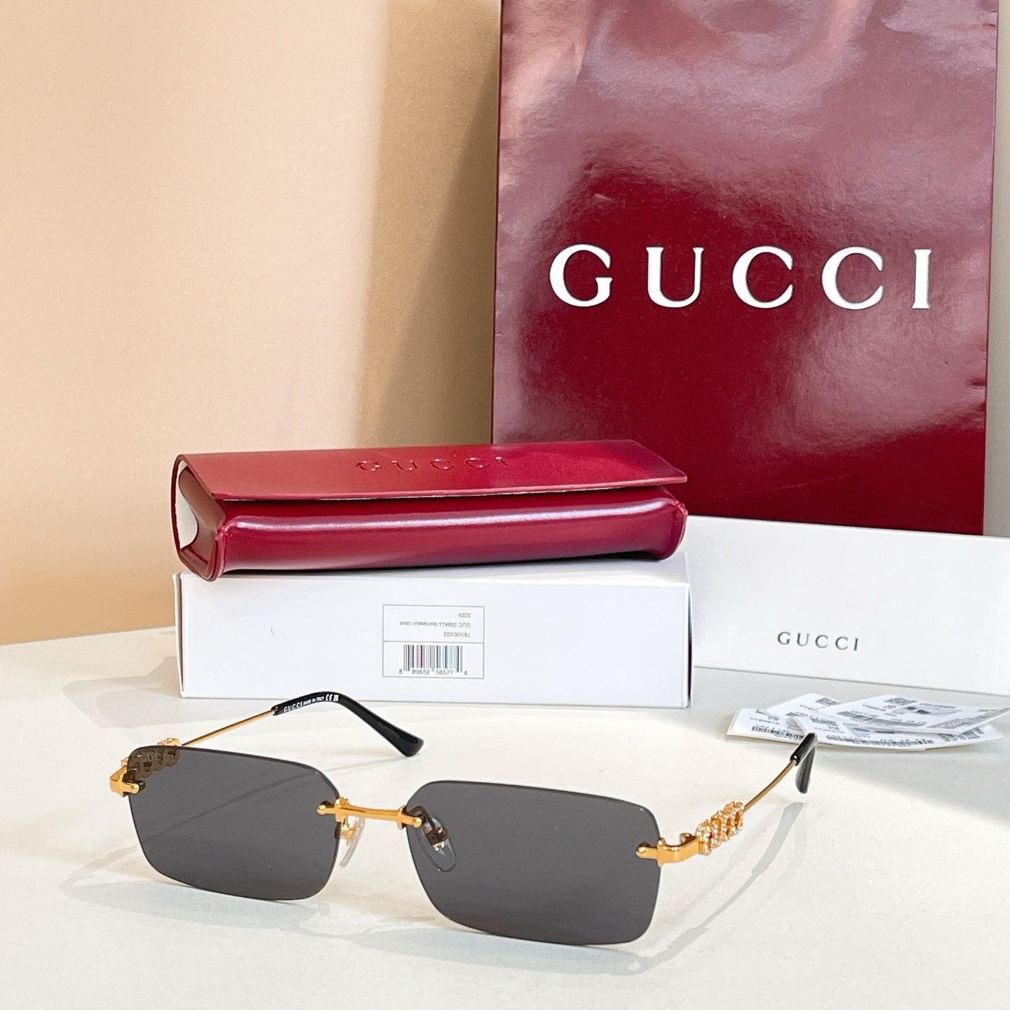 Gucci square sunglasses with charcoal lenses and gold-tone embellished frame