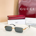 Gucci square sunglasses with dark gray lenses and gold-tone embellished frame