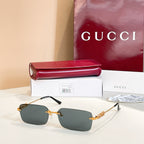 Gucci square sunglasses with dark gray lenses and gold-tone embellished frame