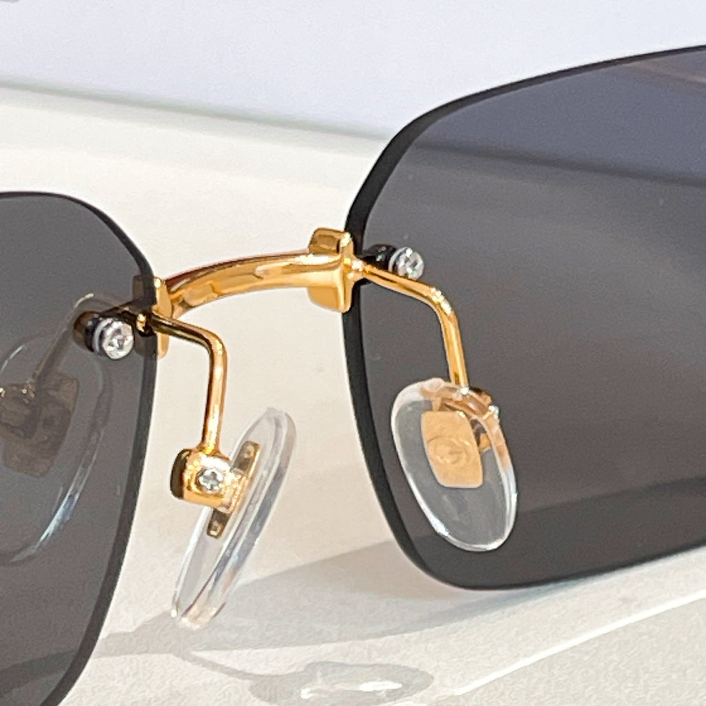 Gucci square sunglasses with dark lenses and gold-tone temple detail