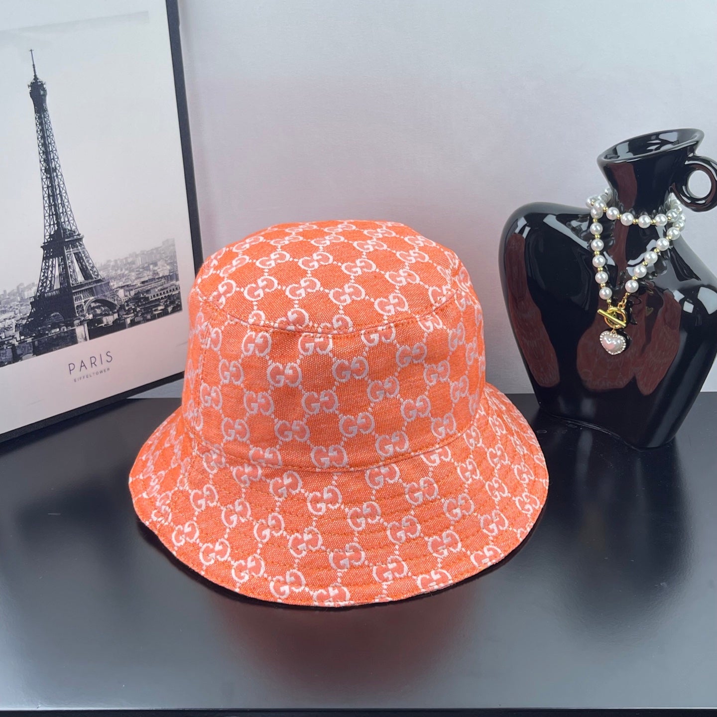 Orange GG-print bucket hat with curved brim and stitched crown