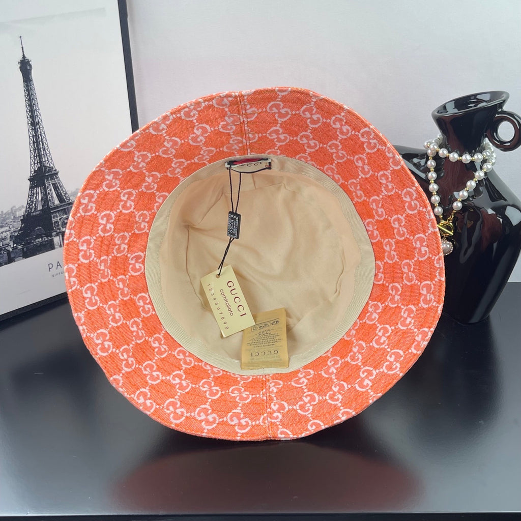 Orange GG-print bucket hat with beige lining and interior tags