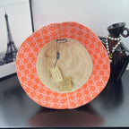 Orange GG-print bucket hat with beige lining and interior tags