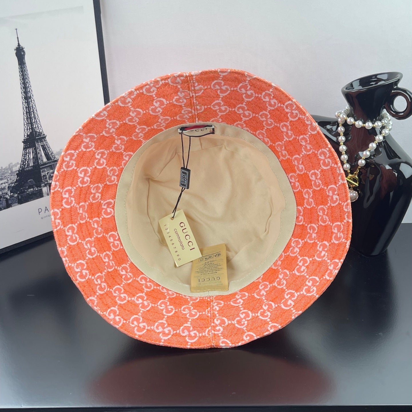 Orange GG-print bucket hat with beige lining and interior tags