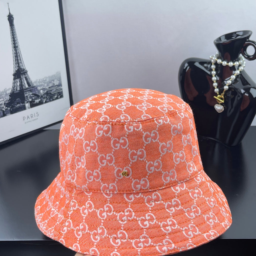 Orange GG-print bucket hat, front panel view with visible stitching