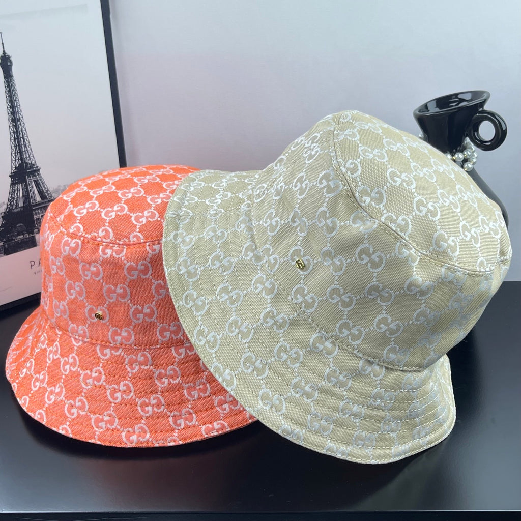 Gucci cap set: light gold and red GG monogram bucket caps, side by side