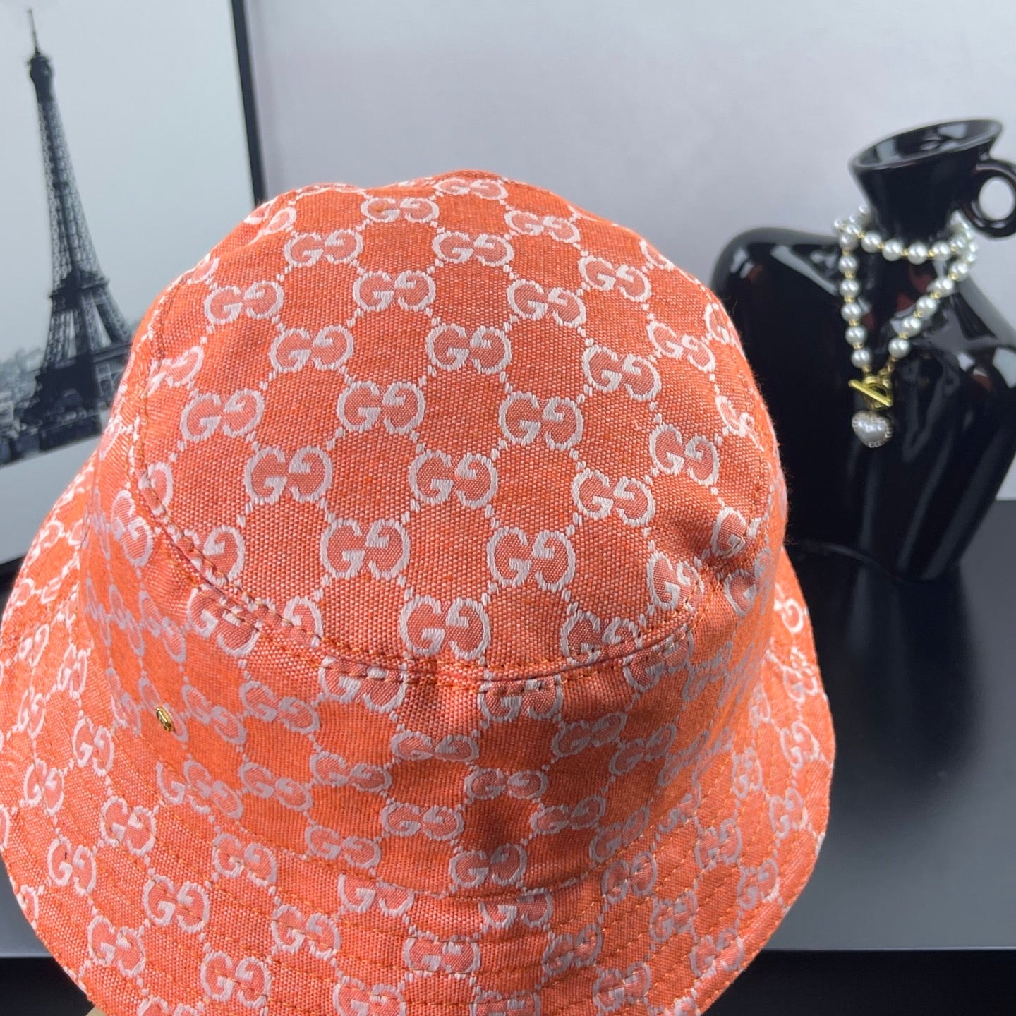 Orange GG-print bucket hat with textured fabric and stitched crown