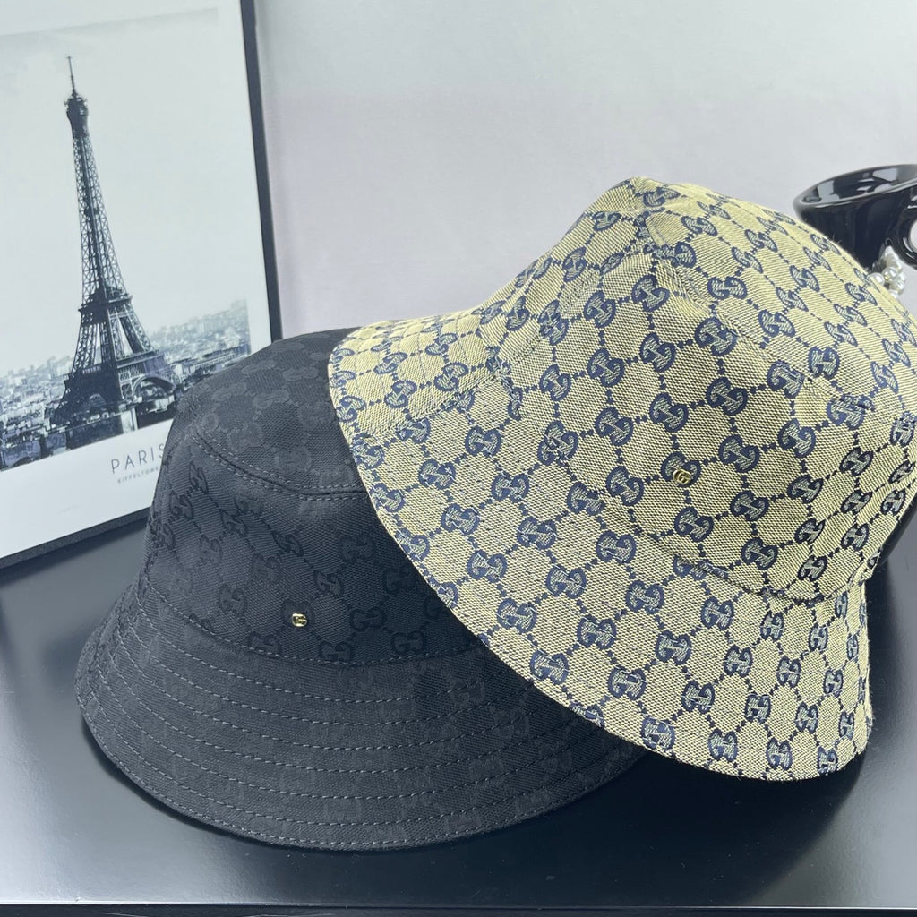 Gucci GG-print bucket cap and dark gray cap, shown side by side