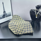 Gucci GG-print bucket cap, light beige with navy pattern on a slanted angle