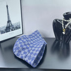 Blue GG monogram bucket cap, folded side profile with stitched brim