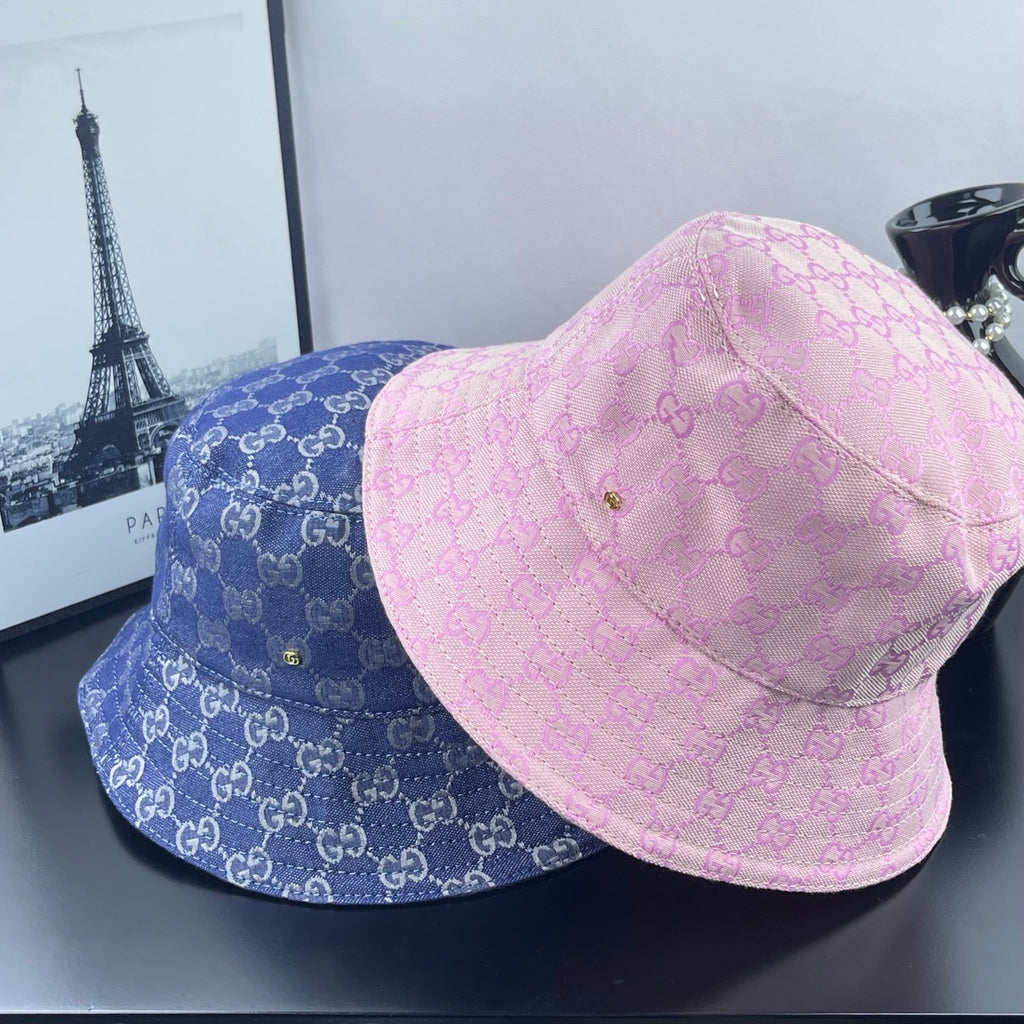 Blue and pink bucket caps with GG monogram pattern and stitched brims