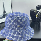 Blue GG monogram bucket cap with gold pin detail and quilted stitching