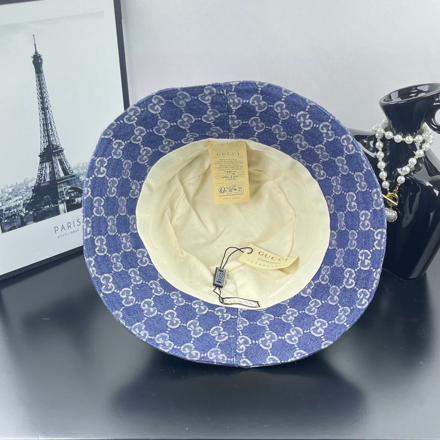 Blue GG monogram bucket cap with beige interior lining and hanging tag