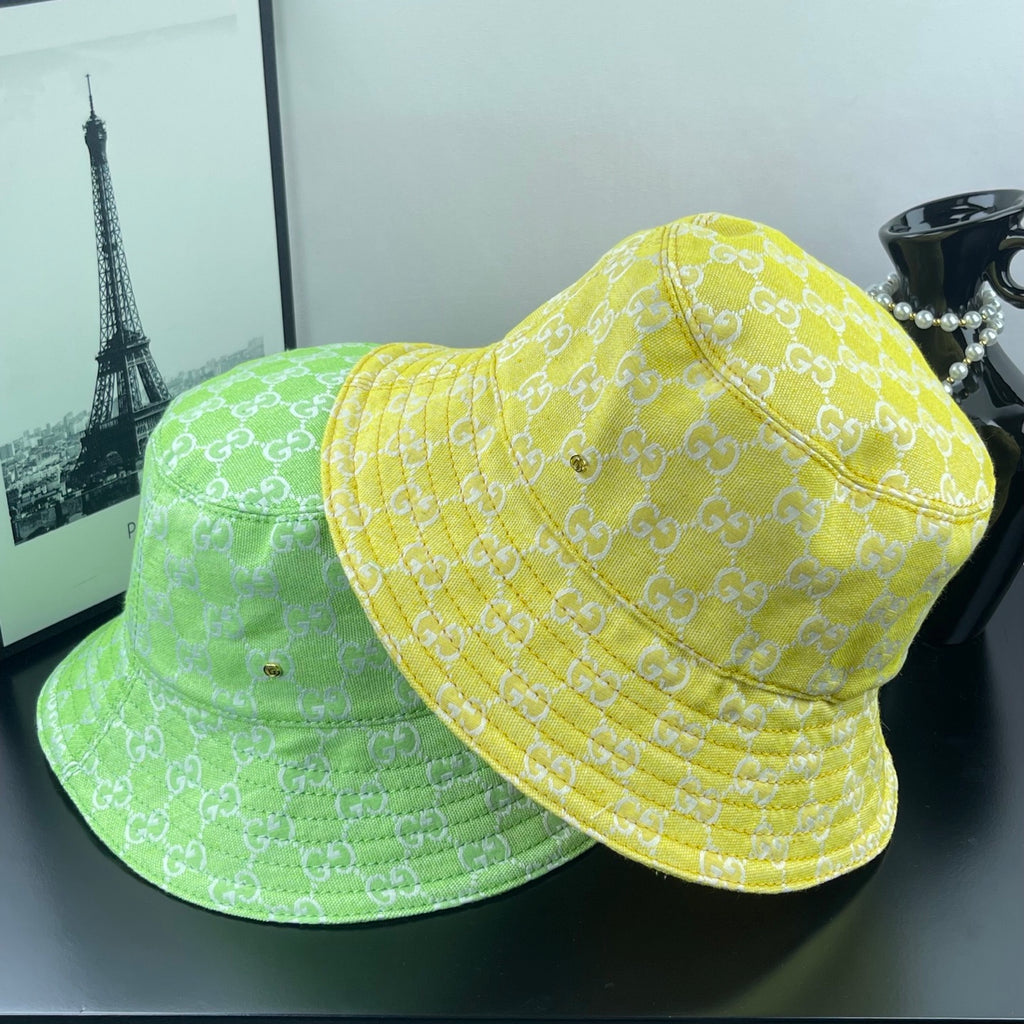 Gucci bucket cap bright yellow with GG monogram, shown beside another similar hat