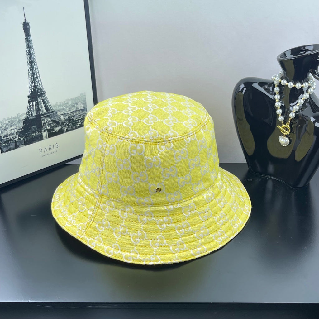 Gucci bucket cap bright yellow with repeating GG monogram pattern and stitched brim