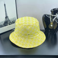 Gucci bucket cap bright yellow with repeating GG monogram pattern and stitched brim