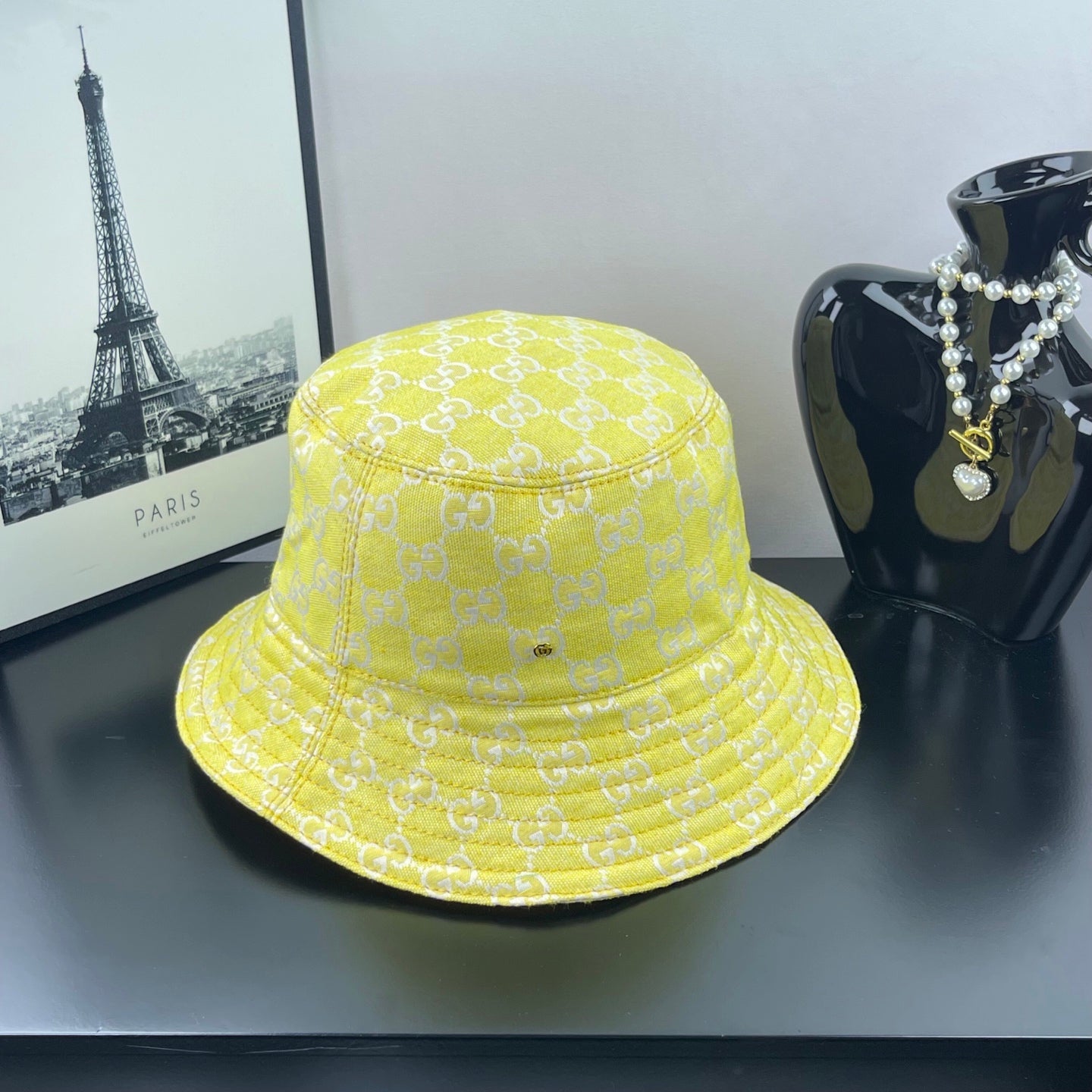 Gucci bucket cap bright yellow with repeating GG monogram pattern and stitched brim