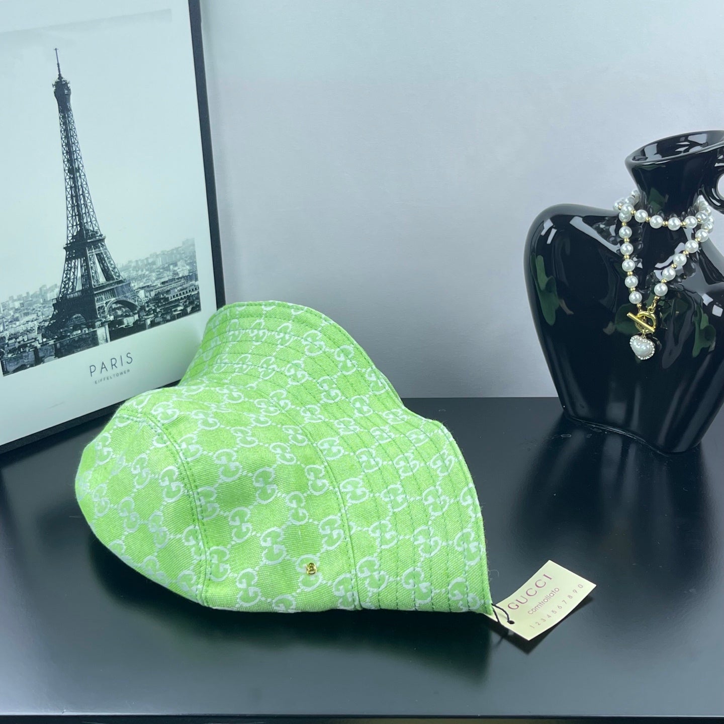 Lime green Gucci bucket hat on display with GG monogram pattern