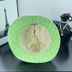 Lime green Gucci bucket hat interior view with beige lining and hang tag