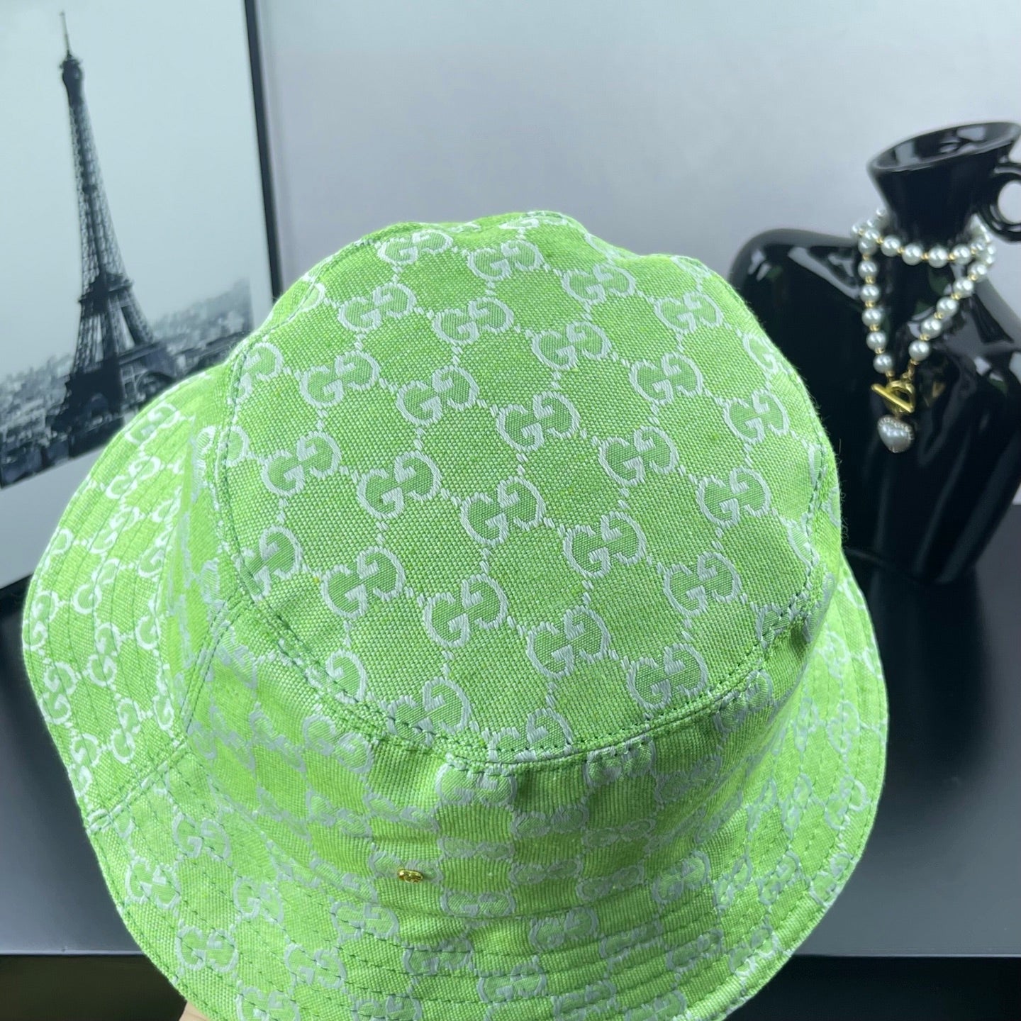 Lime green Gucci bucket hat side view with allover GG monogram pattern