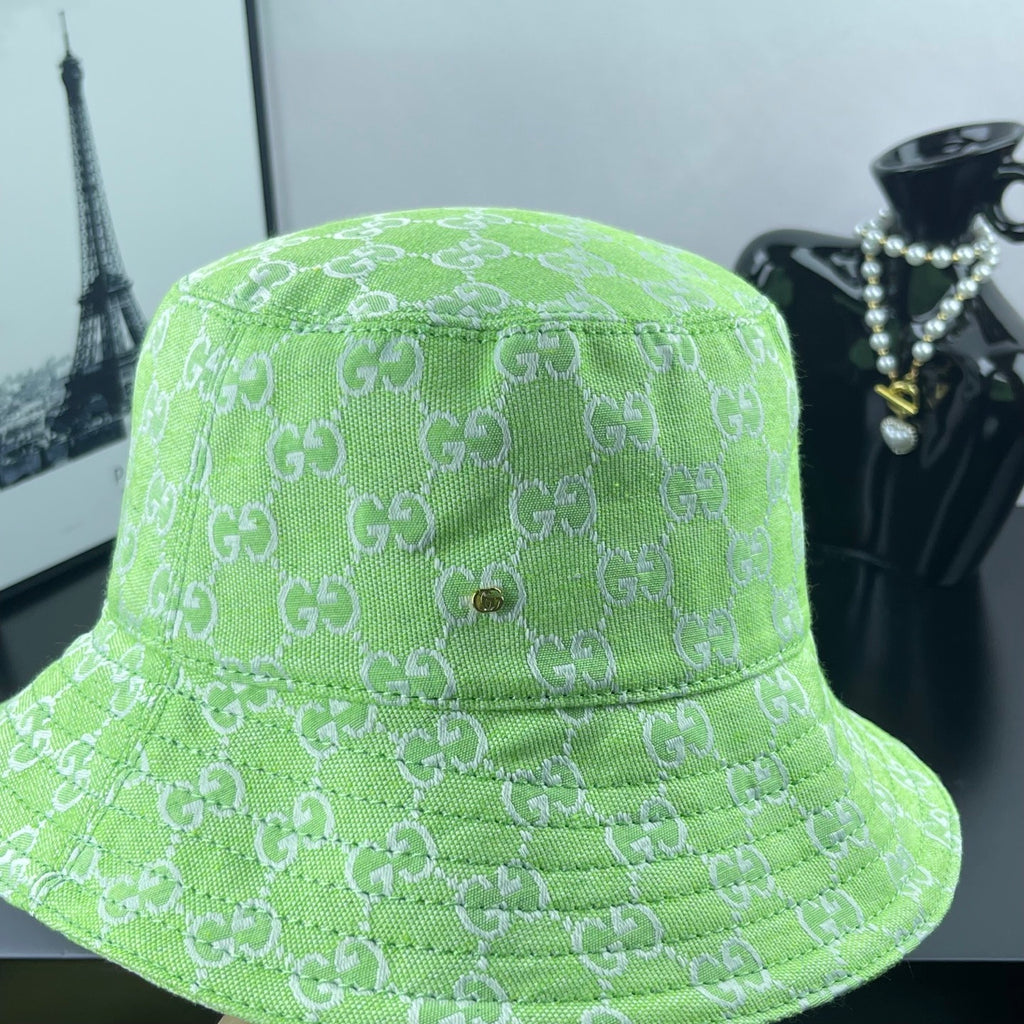 Lime green Gucci bucket hat close-up with GG jacquard and centered gold button