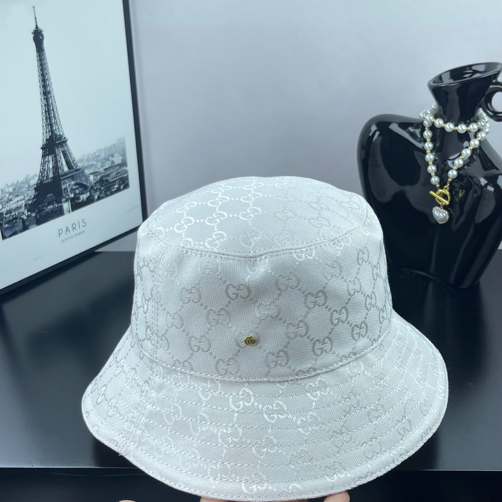 Gucci white GG monogram bucket cap on display, stitched brim and central crown rivet