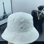 Gucci white GG monogram bucket cap, side view with textured crown and stitched band