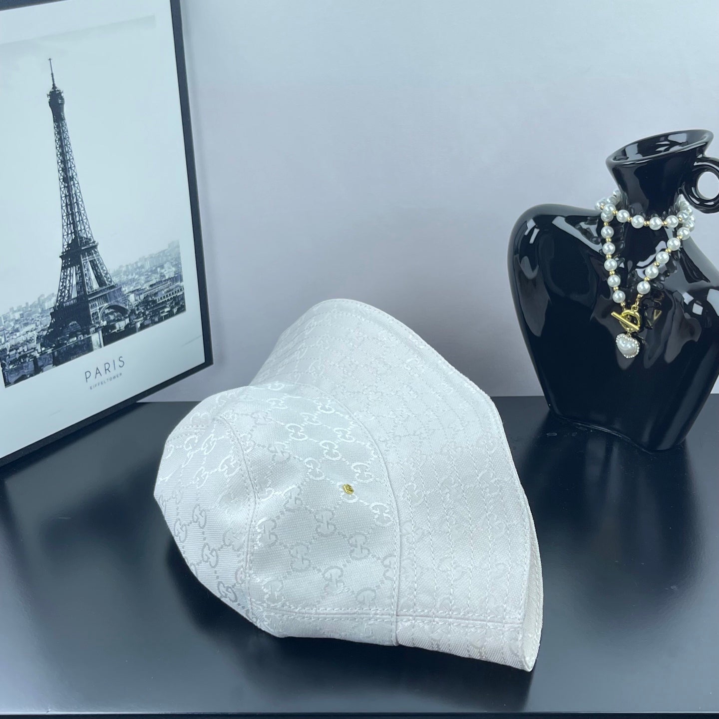 Gucci white GG monogram bucket cap, angled view with textured fabric and stitched brim