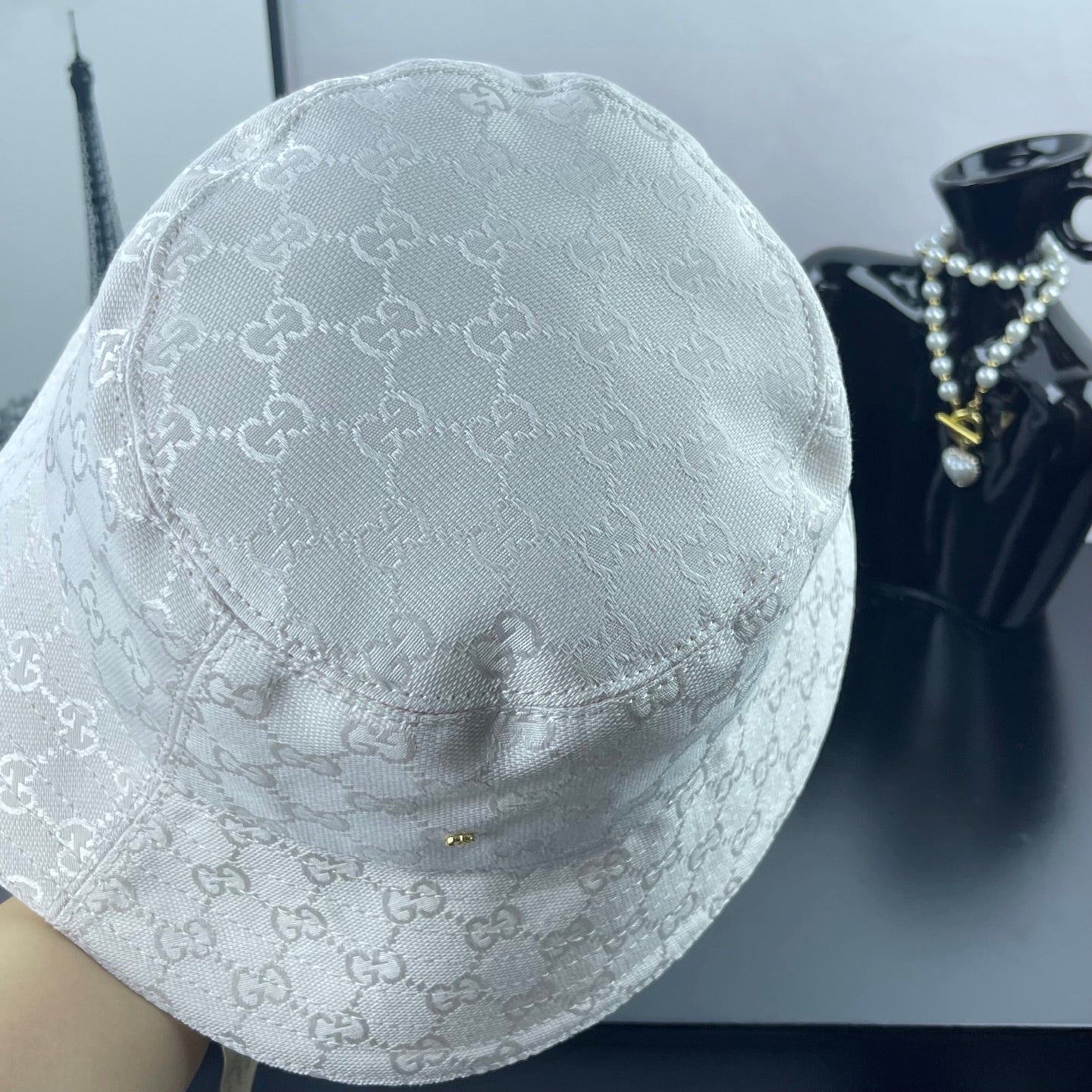 Gucci white GG monogram bucket cap, close view of crown and brim seam