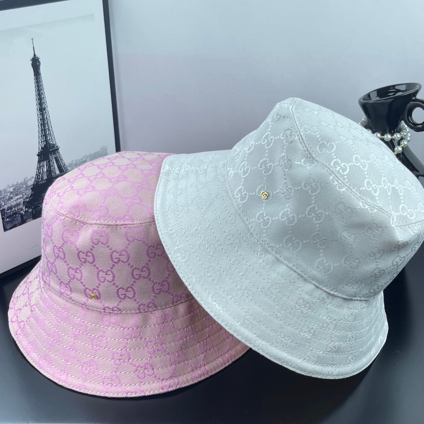 Gucci white and pink GG monogram bucket caps with curved brims and stitched crowns