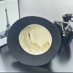 Gray bucket hat interior with cream lining and Gucci-branded hang tags