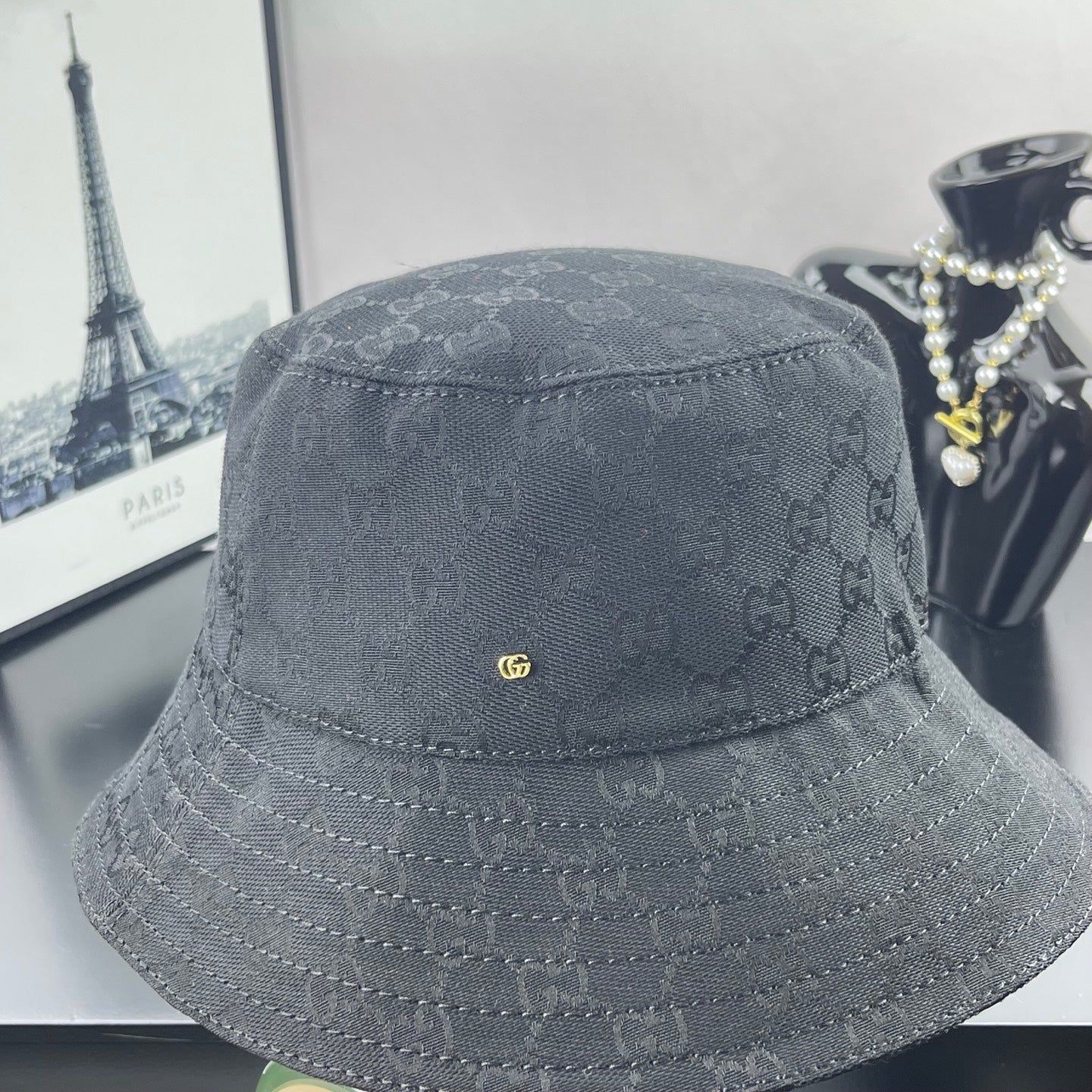 Gray GG monogram bucket hat, side profile with stitched brim