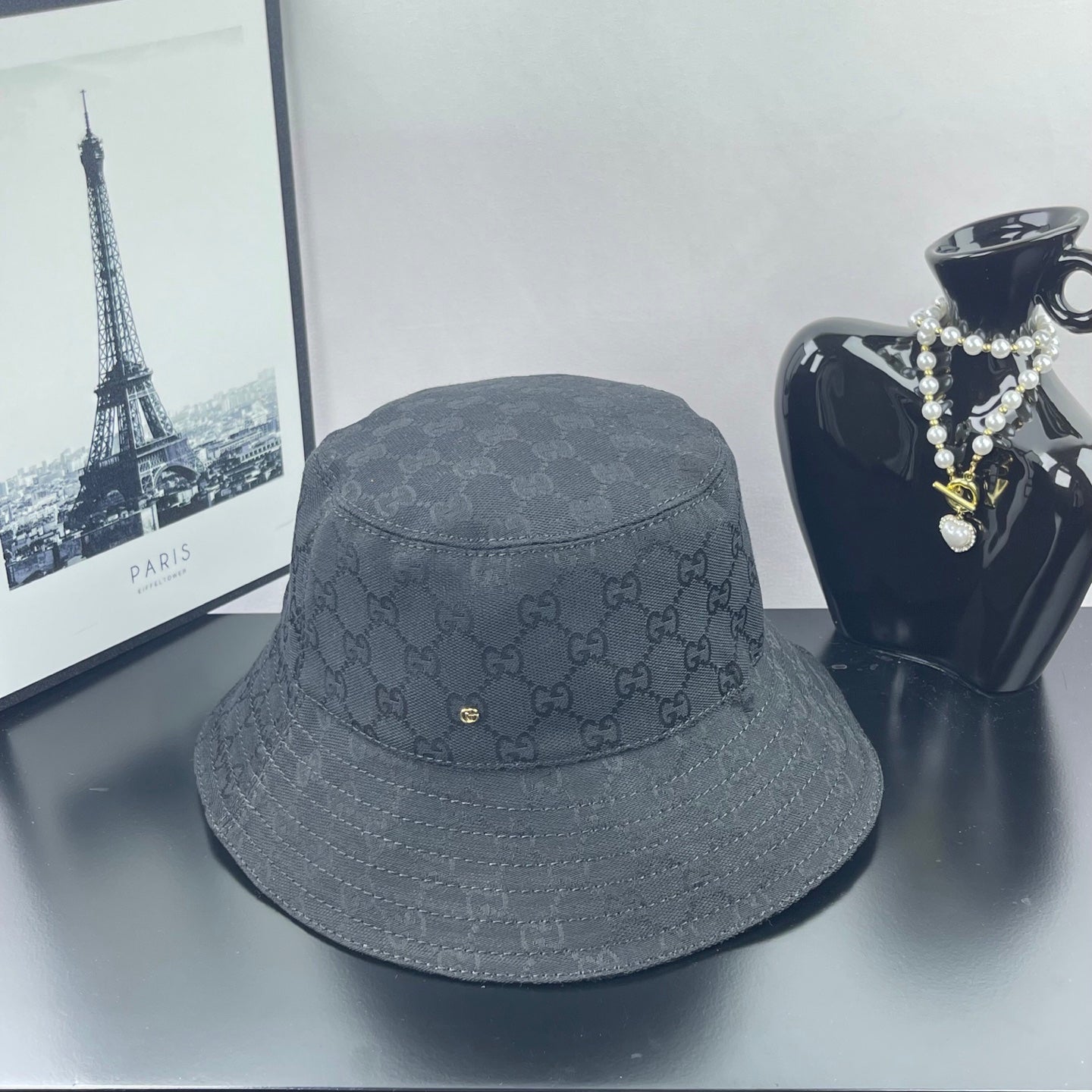 Gray GG monogram bucket hat with gold logo detail