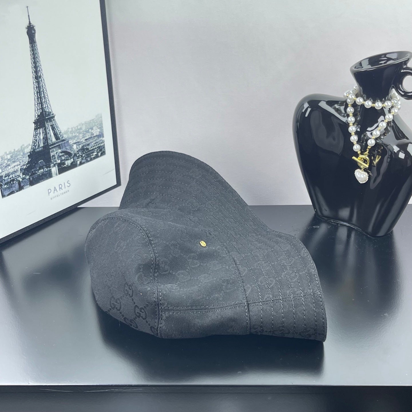 Gray GG monogram bucket hat with front seam and small gold logo