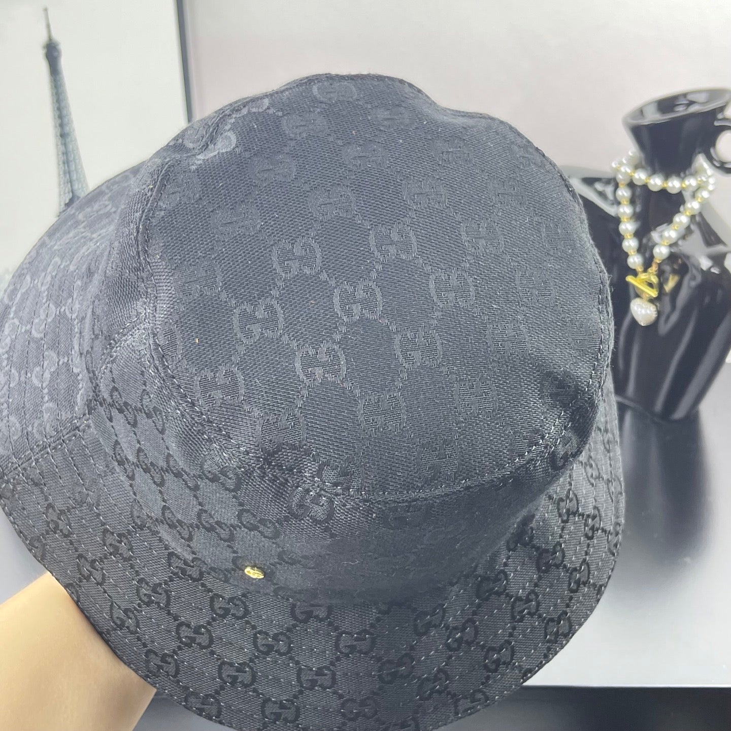 Gray GG monogram bucket hat, back view with small gold logo