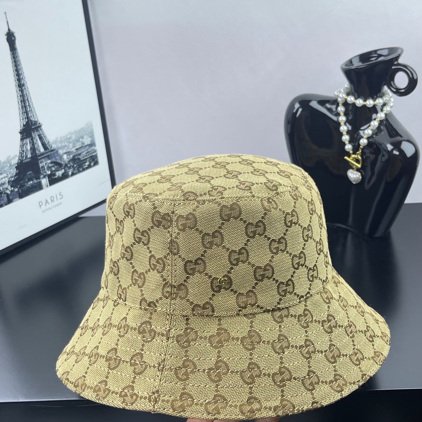 Gucci GG monogram bucket cap, tan with dark brown pattern, front view
