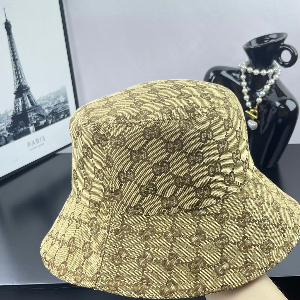 Gucci GG monogram bucket cap, tan with dark brown pattern, three-quarter view