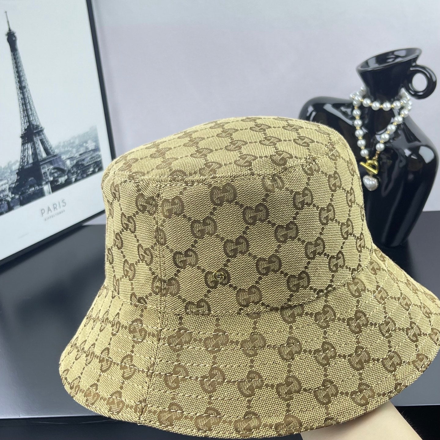 Gucci GG monogram bucket cap, tan with dark brown pattern, three-quarter view