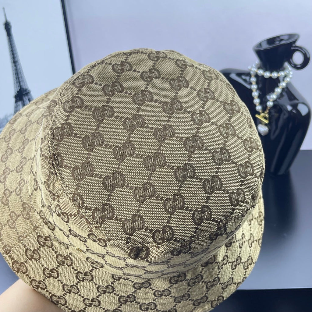 Gucci GG monogram bucket cap, tan with dark brown pattern, close-up top