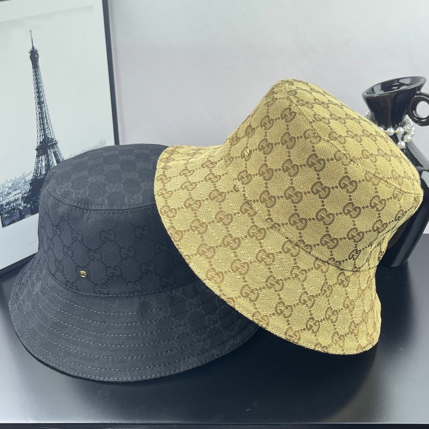 Gucci GG-pattern caps, tan bucket cap and dark gray bucket cap side by side