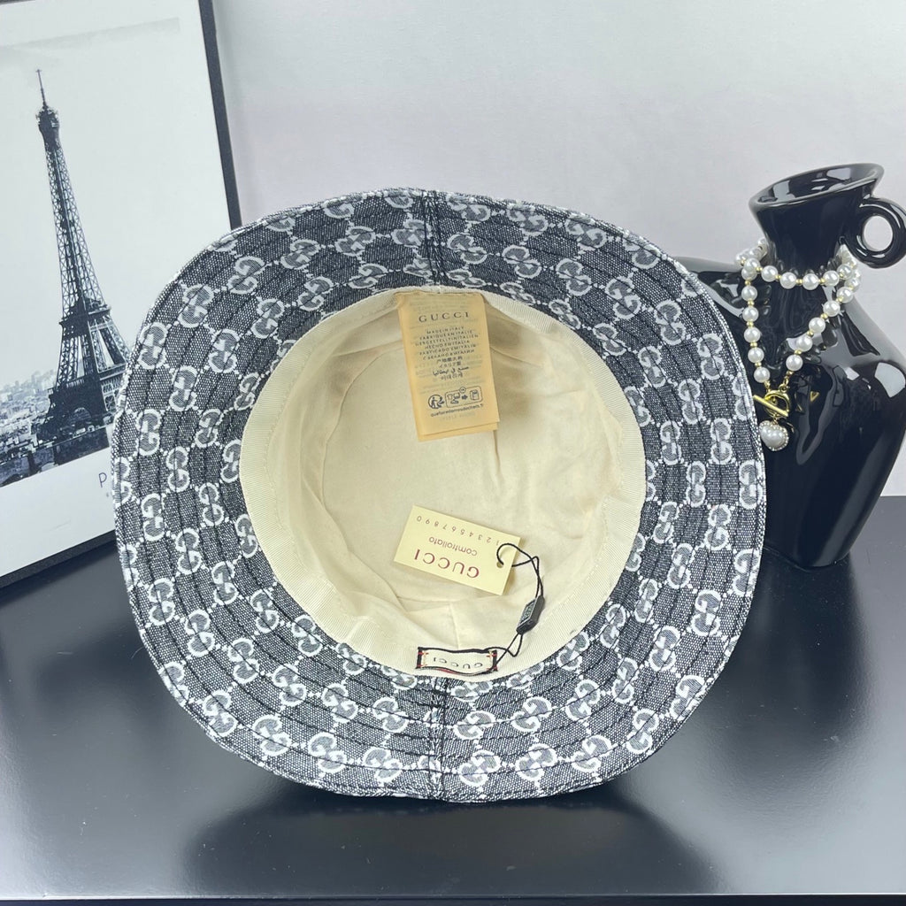 Gucci GG-print bucket hat, dark gray, underside view with cream lining and tags