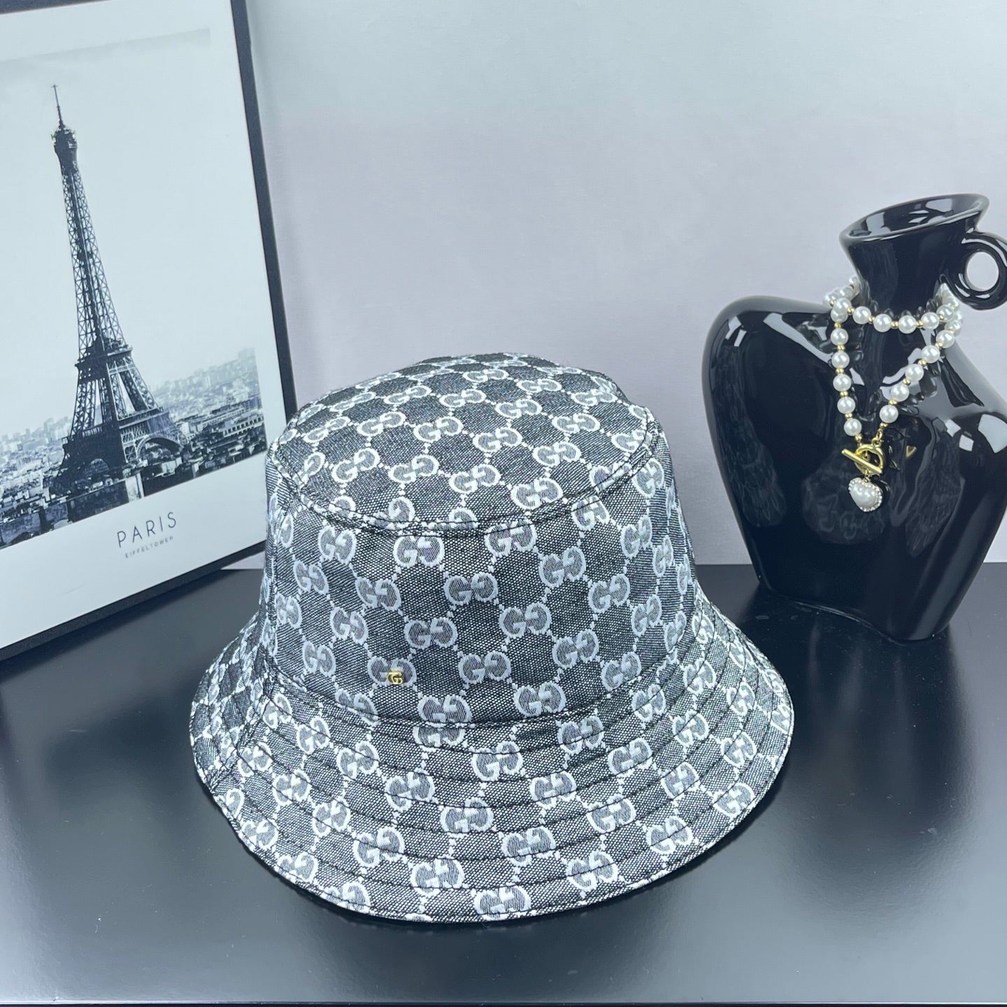 Gucci GG-print bucket hat, dark gray with repeating white logos and stitched brim