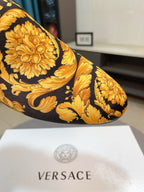 Close-up of yellow and black floral loafer toe with ornate brocade-style print.