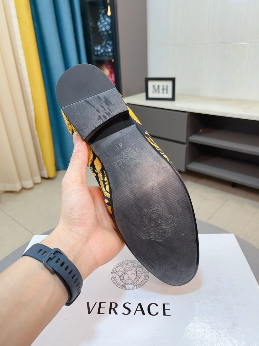 Shoe underside view: dark sole with embossed texture and matching floral top edge.