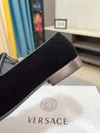 Black velvet loafer with low heel and side opening