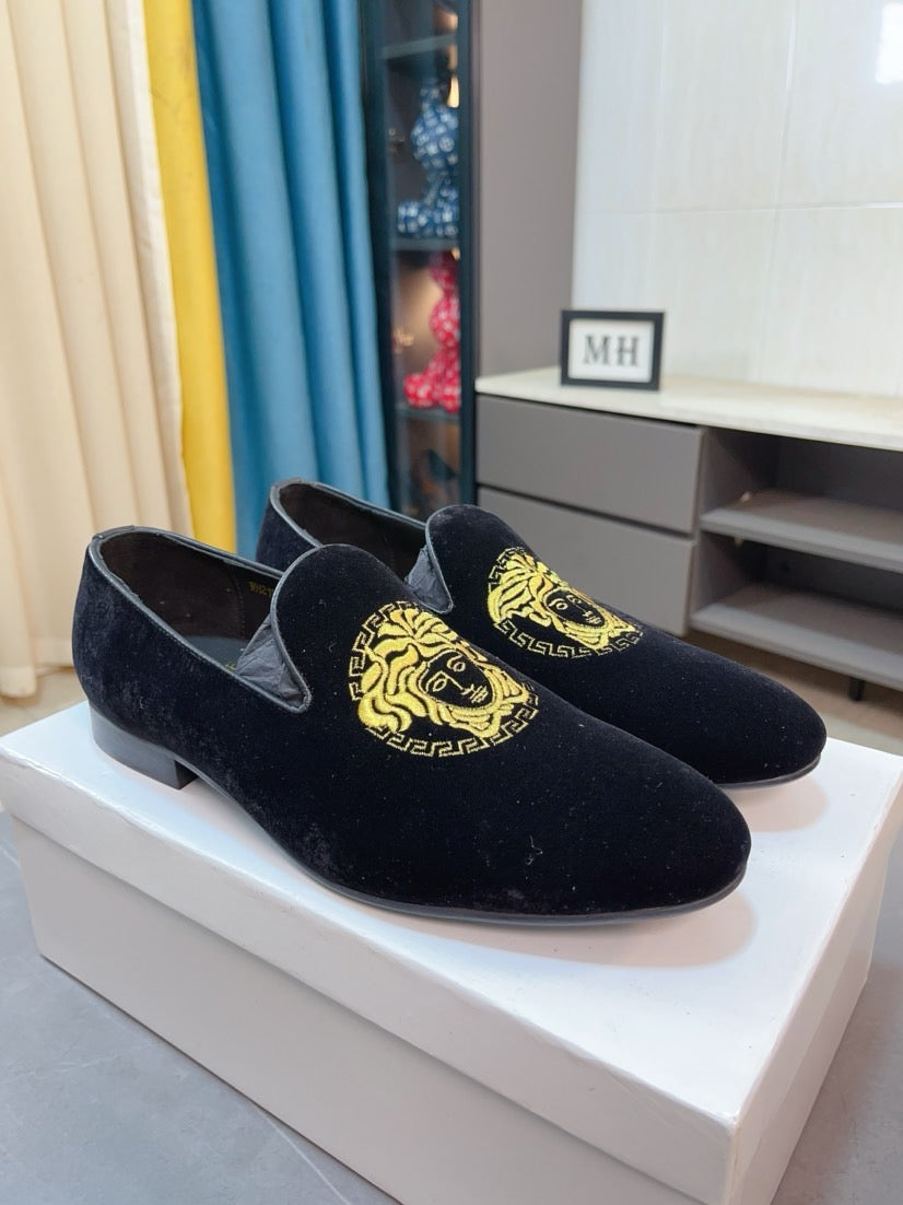 Black velvet loafers with gold Medusa emblem on the vamp